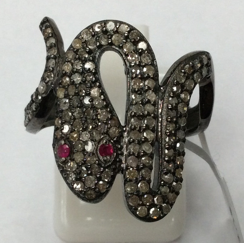 A sterling silver ring with a snake-like design, adorned with pave diamonds