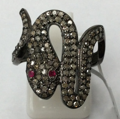 A sterling silver ring with a snake-like design, adorned with pave diamonds