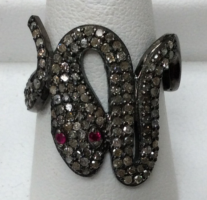 A sterling silver ring with a snake-like design, adorned with pave diamonds