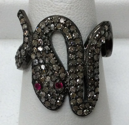 A sterling silver ring with a snake-like design, adorned with pave diamonds