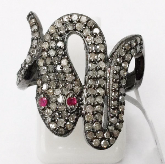 A sterling silver ring with a snake-like design, adorned with pave diamonds.